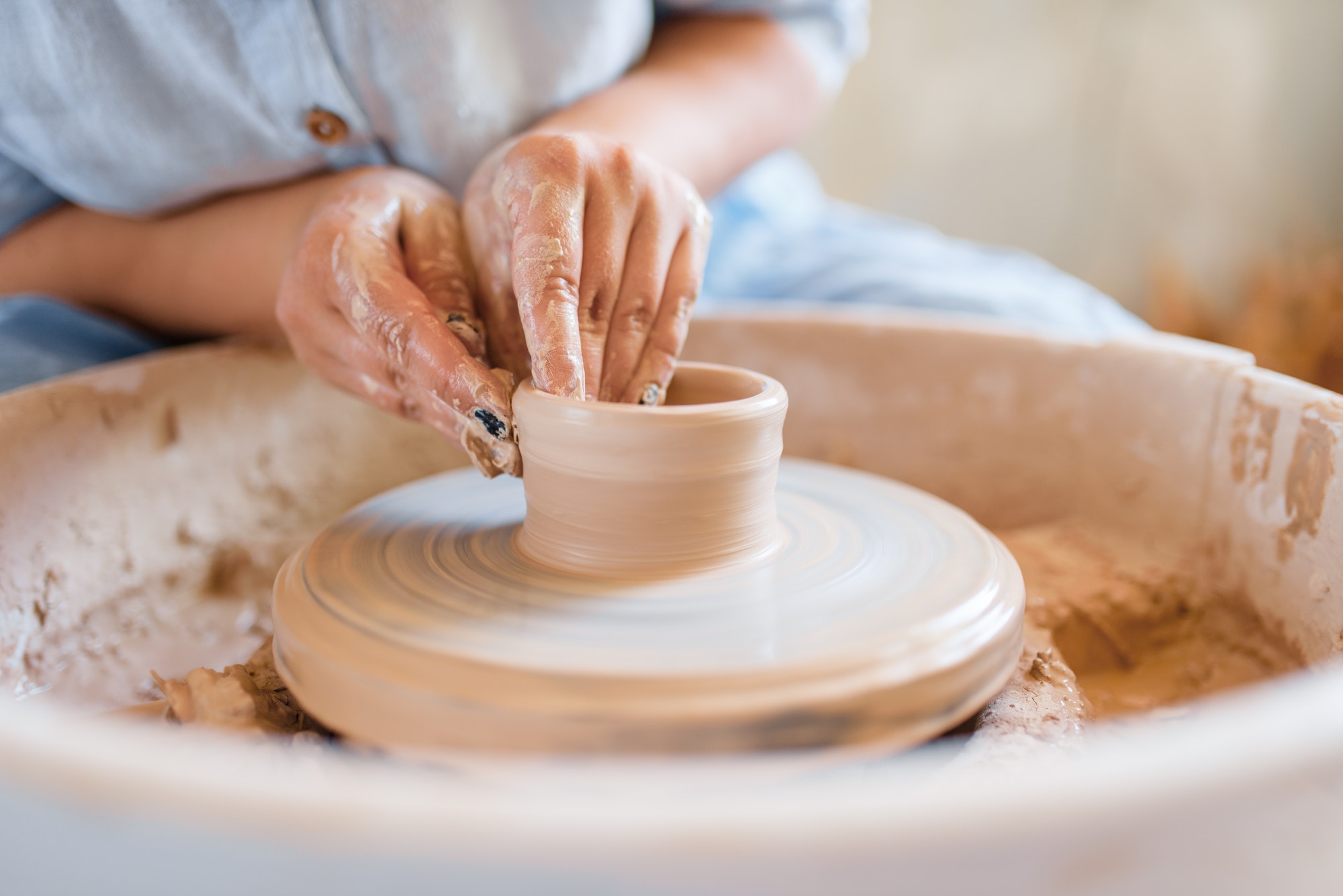 female-potter-making-a-pot-on-pottery-wheel.jpg